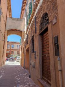 un callejón con un arco entre dos edificios en Al Ventotto di Maria, en Foligno