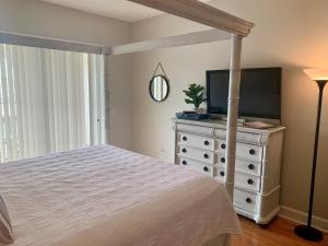a bedroom with a bed and a television on a dresser at Inn at Camachee Harbor View 22 in Saint Augustine