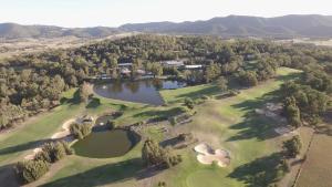 an aerial view of a golf course with two lakes at 1 bedroom Executive Villa located within Cypress Lakes in Pokolbin