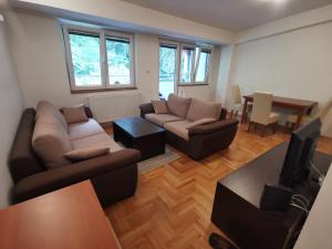 a living room with two couches and a table at Zagrebska flat in Skopje