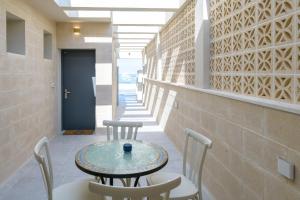 a table and chairs in the hallway of a building at Princess Crown Collection in Neve Zohar +3 photos
