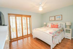 a bedroom with a bed and a ceiling fan at St Augustine Beach & Tennis Resort 808 in Saint Augustine