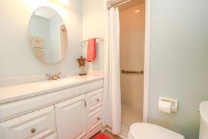 a bathroom with a sink and a toilet and a mirror at St Augustine Beach & Tennis Resort 808 in Saint Augustine +13 photos