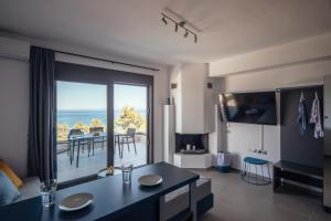 a living room with a view of the ocean at ErMoJo Luxury Apartments in Metókhion Patriotikón