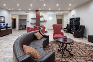 a living room with a couch and a table at Home Away Kitchen Suites Enid in Enid