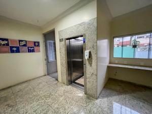an empty room with a door and a window at Canadá Hotel in Rio Verde