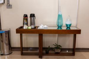 a wooden table with two vases on top of it at Canadá Hotel in Rio Verde