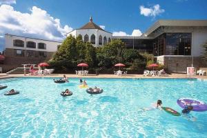 a group of people playing in a swimming pool at Stunning 2 bed Luxury Caravan at Hoburne Devon Bay, with Hot Tub and sea view in Paignton