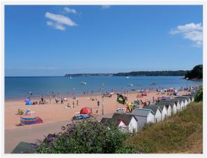 a beach with a bunch of people on the beach at Stunning 2 bed Luxury Caravan at Hoburne Devon Bay, with Hot Tub and sea view in Paignton