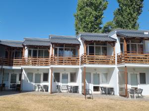 a white building with chairs and tables in front of it at Chata Severka in Senec