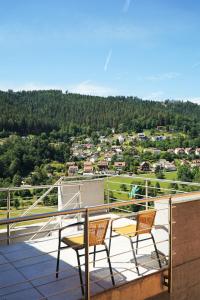 two chairs sitting on a balcony with a view at WiLDBADFERiEN punkt DE in Bad Wildbad