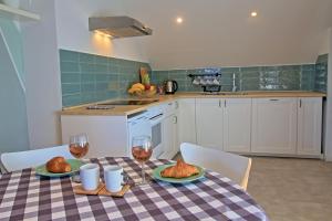 a kitchen with a table with food and glasses of wine at Little Forest in Otočac