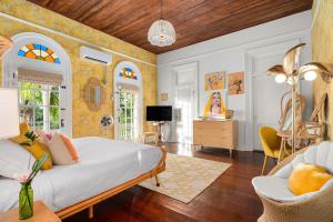 a bedroom with a bed and a living room at Marreros Guest Mansion - Adult Only in Key West
