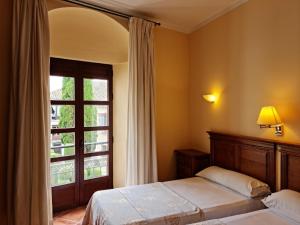 Postel nebo postele na pokoji v ubytování Hotel Plateros