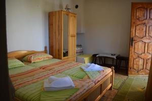 a bedroom with a bed with towels on it at Guest house Nedyalkovi in Chernomorets