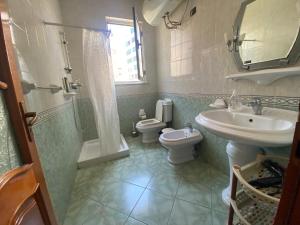 uma casa de banho com um lavatório, um WC e um chuveiro em Tirana Apartment em Tirana