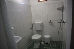 a bathroom with a toilet and a sink and a shower at Guest house Nedyalkovi in Chernomorets +20 photos