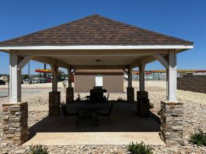 a pavilion with a table and chairs under it at Microtel Inn & Suites by Wyndham Sweetwater in Sweetwater