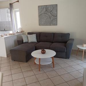 a living room with a couch and a table at Meteora Casa Di Stella in Kalabaka