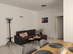 a living room with a couch and a table at Apartments Erenda in Fuškulin