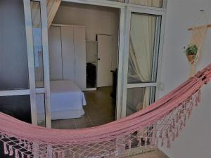 a hammock in a room with a bedroom at Mommy's Apartment in Copacabana in Rio de Janeiro