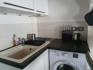 kuchnia ze zlewem i pralką w obiekcie EXIGEHOME-Studio Cosy à 2 pas du Chateau de Versailles w Wersalu