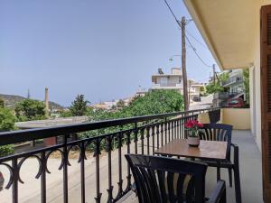 a patio with a table and chairs on a balcony at Tonia's Place in Ermioni