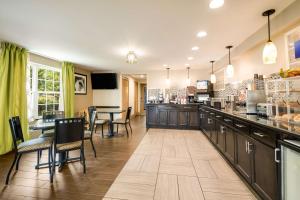 a restaurant with a counter and a table and chairs at Best Western Inn Winchester in Winchester