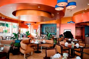 a restaurant with tables and chairs and a large ceiling at All Inclusive Divi Little Bay Beach Resort in Philipsburg