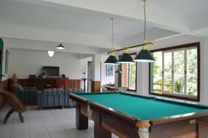 a living room with a pool table at Artesanal Gourmet e Pousada in Posse