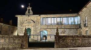 a church with a cross on top of a fence at Solar De Alarcao in Guarda