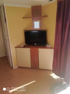 a living room with a flat screen tv on a stand at CASITA AZUL MUÑICO , AVILA in Muñico +20 photos