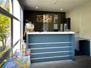 a blue and white counter in a room with a window at Beaches Nelson in Nelson