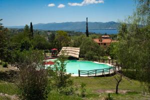 a swimming pool in the middle of a field at Capilla del Lago in Villa Carlos Paz