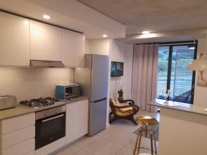 a kitchen with white cabinets and a stove top oven at Umhlanga Vacation Home with Free WiFi in Sibaya
