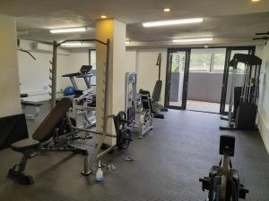 a gym with treadmills and machines in a room at Umhlanga Vacation Home with Free WiFi in Sibaya
