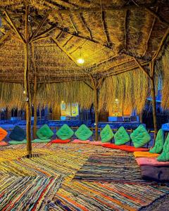 a room with many colored pillows and a straw ceiling at sea horse in Nuweiba