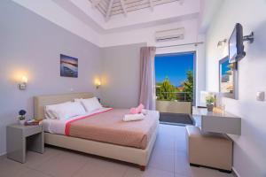 a bedroom with a bed and a large window at Villa Rubi by Villa Plus in Karavomylos +12 photos
