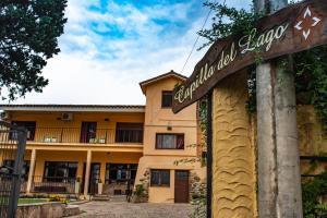 a sign for a hotel in front of a building at Capilla del Lago in Villa Carlos Paz +7 photos