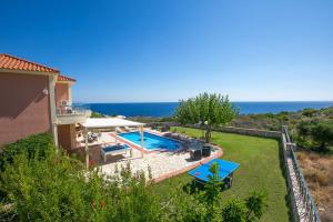 a villa with a swimming pool and the ocean at Villa Skala Bayview by Villa Plus in Spathíon