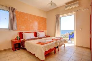 a bedroom with a bed and a large window at Villa Skala Bayview by Villa Plus in Spathíon +19 photos
