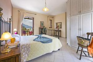 a bedroom with a bed and a table and chairs at Villa Sandy Cove by Villa Plus in Spartia