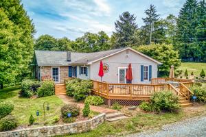 a home with a large deck and a house at Birdsong Rambler in Weaverville