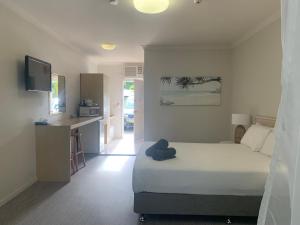 Postel nebo postele na pokoji v ubytování Woolgoolga Coast Motel