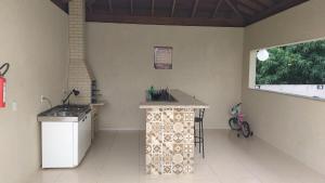 a kitchen with a counter in the corner of a room at Apto novo em Condominio com vista as Montanhas. in Serra Negra