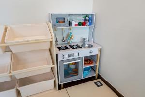 a toy kitchen with a stove and a sink at Haevichi Private Pension in Seogwipo