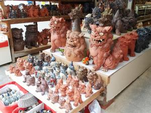 a group of ceramic cats on shelves in a store at Hotel Abest Naha Kokusai Street in Naha