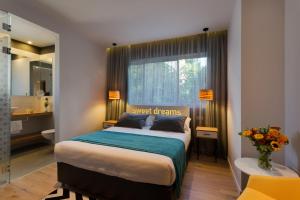 Postel nebo postele na pokoji v ubytování Prima City Hotel