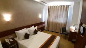 Postel nebo postele na pokoji v ubytování Xtra Hotel Bengkulu