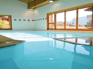 ein leerer Pool mit blauen Böden und Fenstern in der Unterkunft Appartement Samoëns, 3 pièces, 6 personnes - FR-1-624-111 in Samoëns